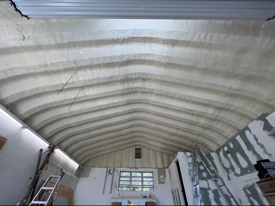 Spray polyurethane foam applied to the underside of a metal roof deck in Covington